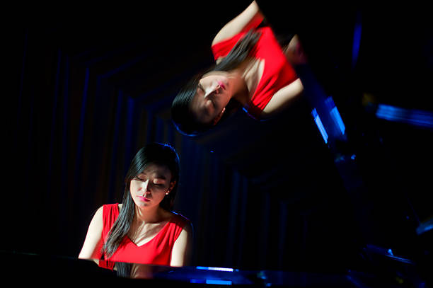 istock beautiful woman playing piano 507260358