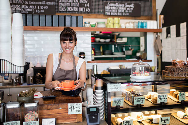 Serving coffee Woman serving coffee in a cafeteria. cafe sandwich stock pictures, royalty-free photos & images