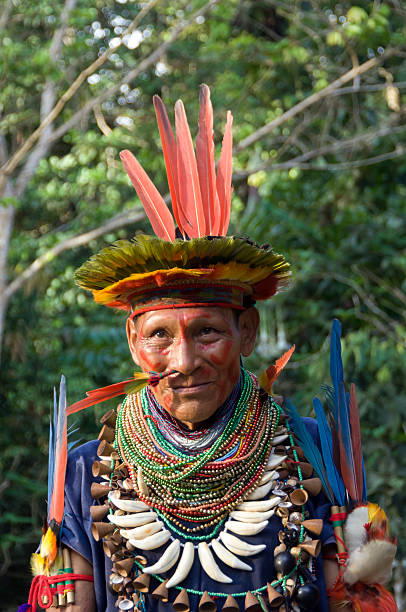 Shaman in Ecuador Rainforest Cuyabeno, Ecuador - October 28, 2006: A shaman healer in the the Amazonian rainforest, Cuyabeno National Park. floating platform stock pictures, royalty-free photos & images