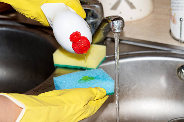 istock woman washing dishes in the kitchen 507262430