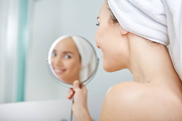 istock beautiful girl touching her face with a towel on  head 507264010