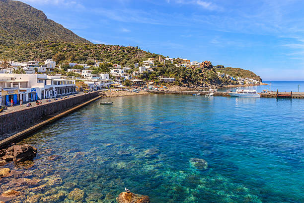 Panarea, Aeolian Islands, Sicily Panarea, Italy - May 11, 2014: Tourists are strolling in the small village of white buildings of Panarea, with the restaurants and bar on the seaside. The island is a inactive volcano and is the second smallest island of the archipelago. panarea island stock pictures, royalty-free photos & images