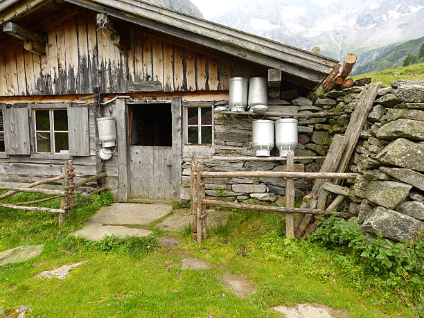 Hut with milk cans in front of the house