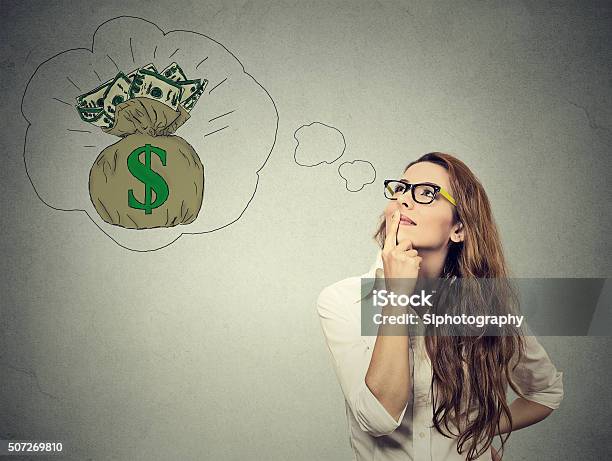 Woman Dreaming Of Financial Success Stock Photo - Download Image Now - Currency, Dreamlike, Day Dreaming