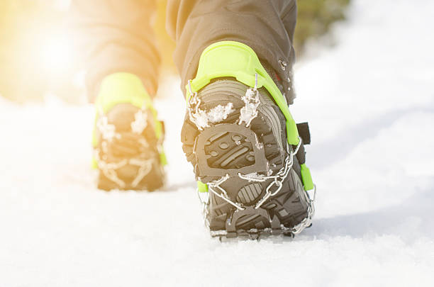 istock Hiking boots with equipment for ice on a snow background. 507270366