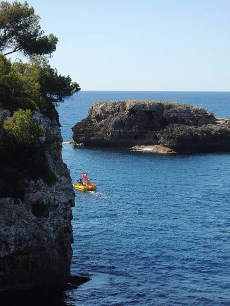 Paddleboat on ambitious voyage near Cala d'Or, Mallorca, Spain