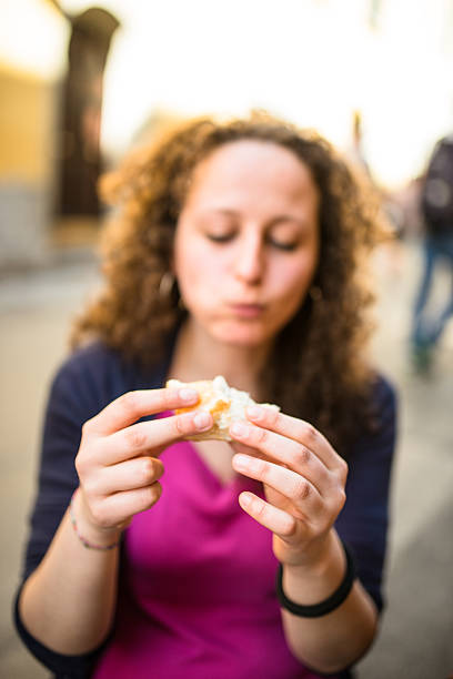 istock woman biting a snack at the cafe 507270753