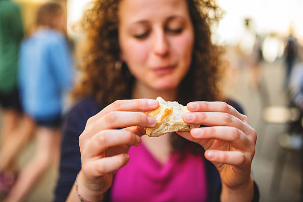 istock woman biting a snack at the cafe 507270835