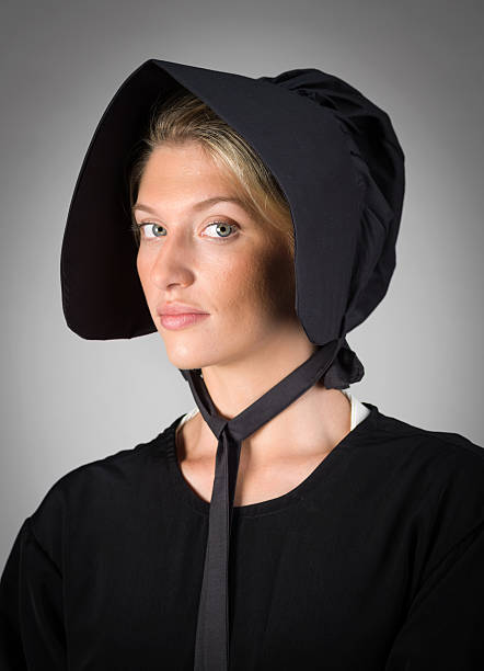 Real Amish Mennonite Young Woman Real Amish Mennonite young woman posing looking at the camera (this picture have been shot with a Hasselblad HD3 II 31 megapixels) bonnet hat stock pictures, royalty-free photos & images
