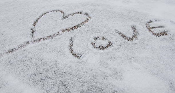 istock love drawing on snow in the winter 507272190