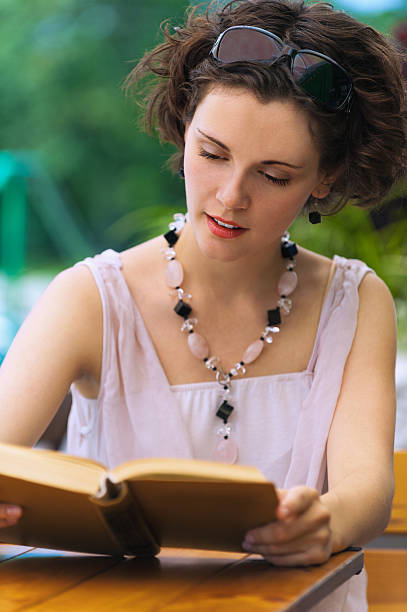 istock girl with book outdoors 507272223