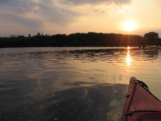 istock View from kayak on the lake at sunset 507272224
