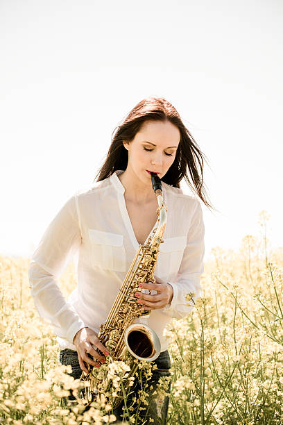istock Woman playing saxophone in nature 507273438