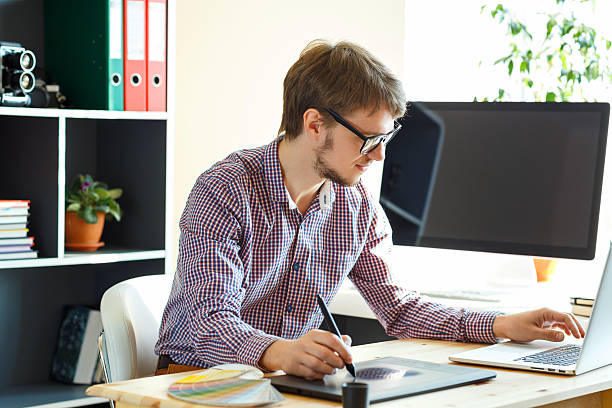 istock Artist drawing something on graphic tablet at the home office 507273898