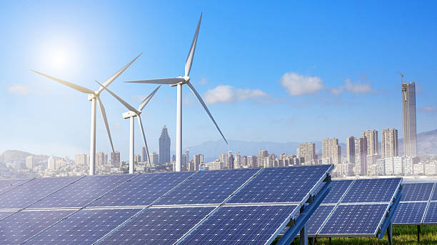 istock Solar panels and wind turbines with city 507275170