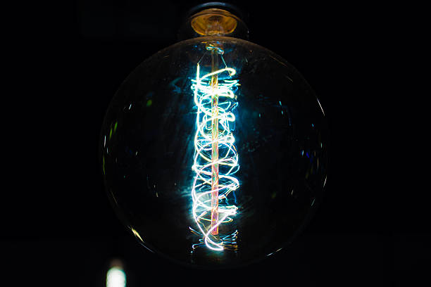 istock wire of light bulb in dark room 507279494