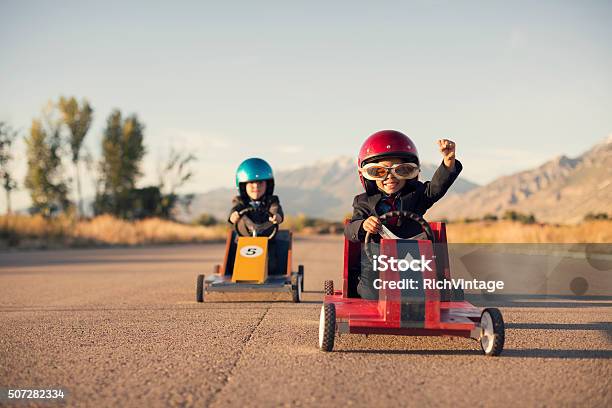 Young Business Boys In Suits Race Toy Cars Stock Photo - Download Image Now - Child, Competition, Winning