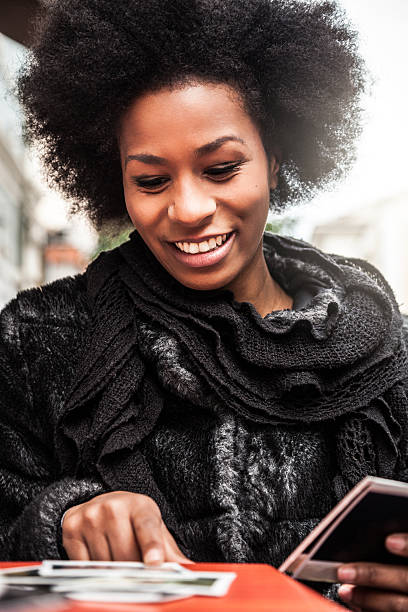 istock Young woman browses instant camera photo frames 507282382