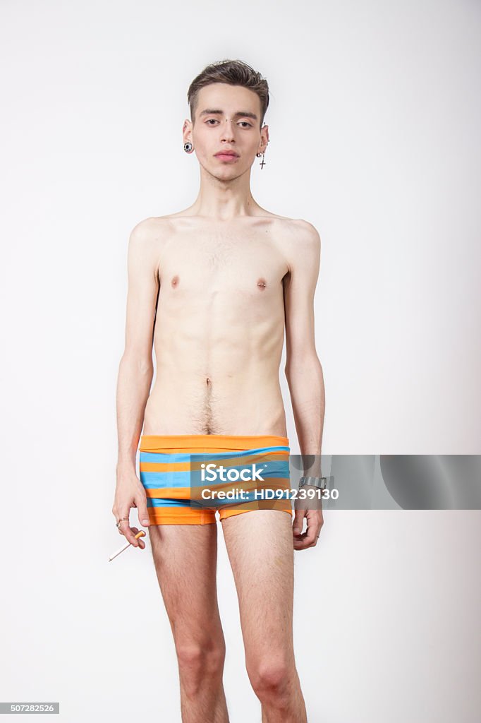 Young man with anorexia nervosa problem. Young man with anorexia nervosa problem. White background. Slim Stock Photo