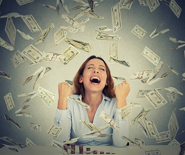 istock woman with growing stack of coins under money rain 507283770