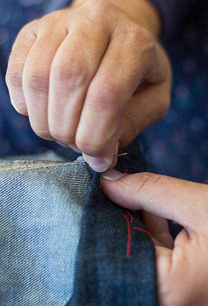 istock Close-up of woman's hands sewing 507285178