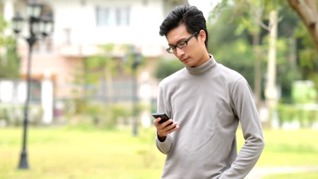 Man use smart phone at Garden park
