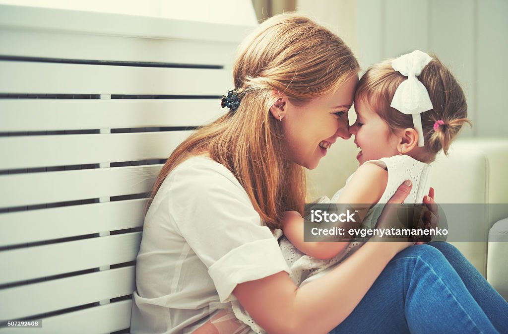 Happy loving family. mother and child playing,  kissing and hugg Happy loving family. mother and child girl playing, kissing and hugging Adult Stock Photo