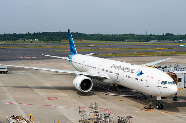 Tokyo, Japan - June 15, 2015: A Garuda Indonesia plane being serviced on the tarmac of Tokyo Narita Airport. Headquartered at Soekarnoa Hatta International Airport in Tangerang, near Jakarta, the airline is the flag carrier of Indonesia.