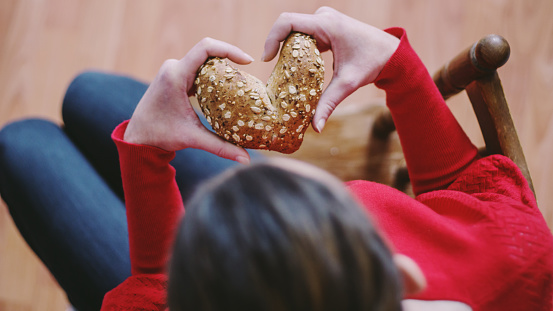 woman holding heart shaped bread