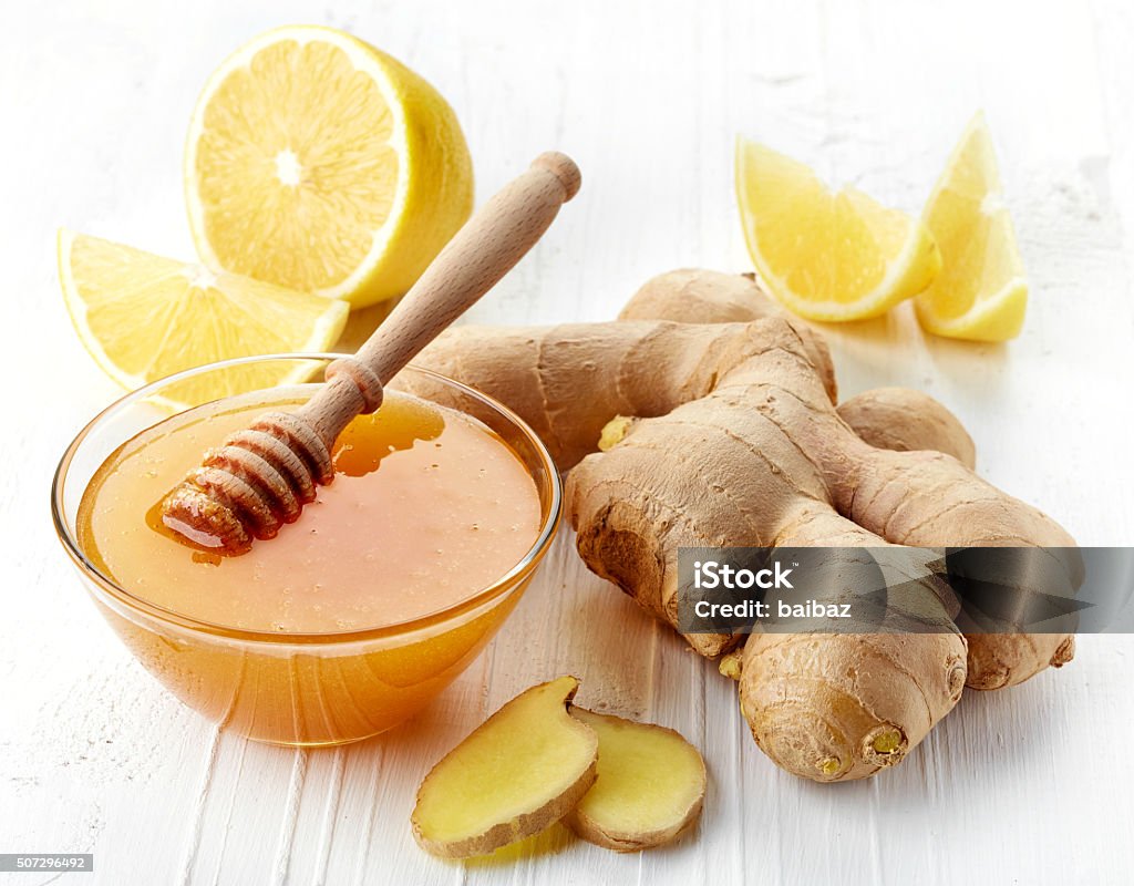 Ginger root Fresh ginger root, honey and lemon on white wooden background Asia Stock Photo