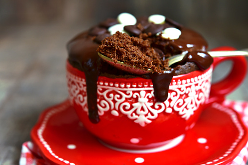 Chocolate mug cake decorated with chocolate glaze.