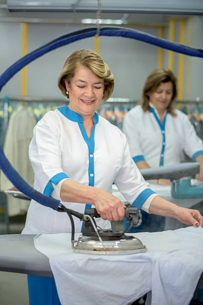 istock Women ironing clothes at a laundry shop 507298040