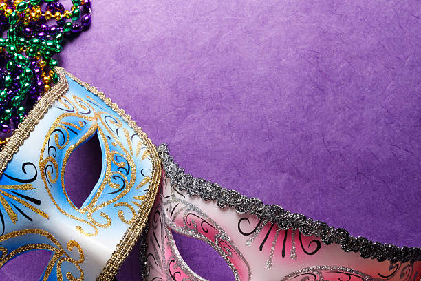 istock Two Mardi Gras Masks And Beads On A Purple Background 507298084