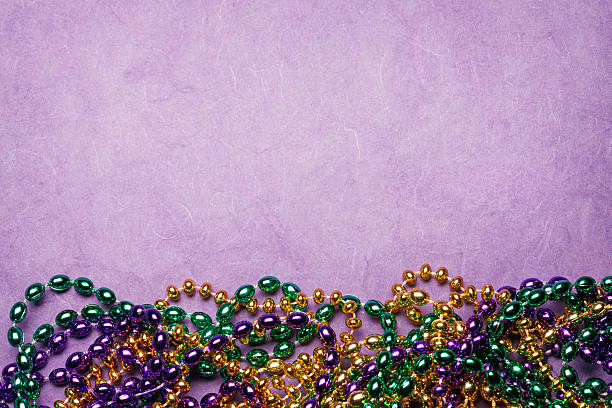istock MMardi Gras Beads On A Purple Background 507298312