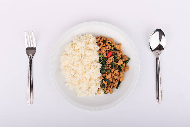 istock Rice topped with stir-fried chicken and basil on isolated 507300588