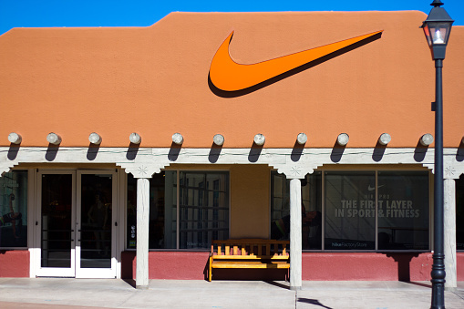 Santa Fe, USA- January 29, 2016: A Nike factory outlet shop in Santa Fe, NM. The store, with the Nike swoosh logo, is constructed in the typical Pueblo adobe architectural style of New Mexico.