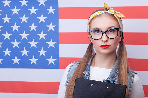 istock Cheerful American female student with folder of documents 507300852