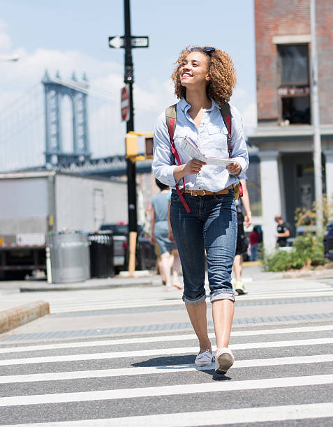 istock Exchange student walking around the city with a map 507301470