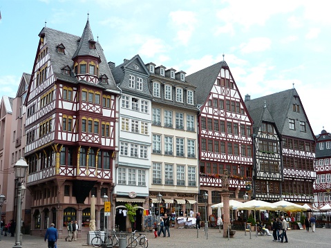 Frankfurt - Main, Germany - June 19, 2011:   Half timbered houses in Romerplatz, with tourists strolling around in the summertime.