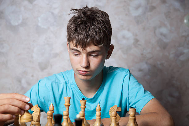 istock Teenager playing chess 507307154