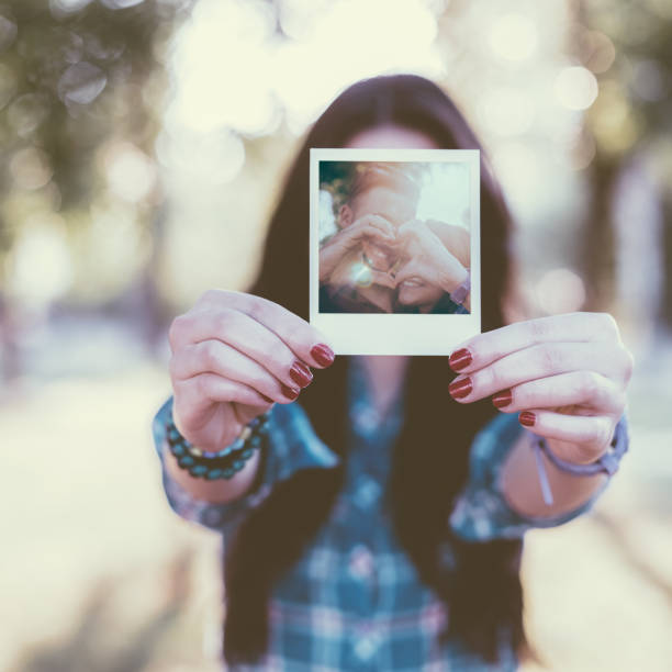 istock Girl showing instant photo 507307240