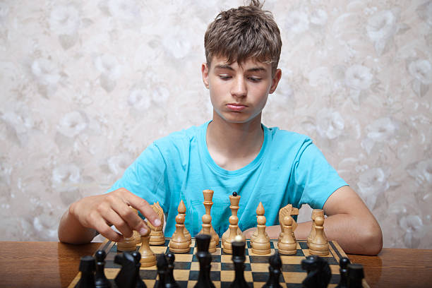 istock Teenager playing chess 507307372