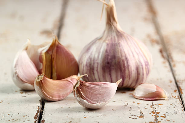istock Garlic bulbs and cloves on wooden table 507309775