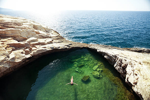 piscina naturale giola sull'isola di taso, grecia - sea swimming greece women foto e immagini stock