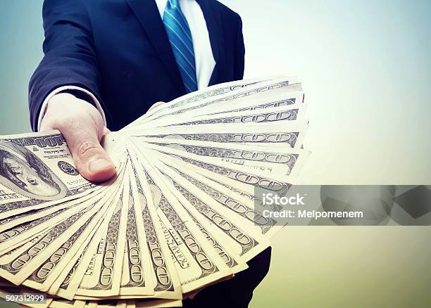 Business Man Displaying A Spread Of Cash Stock Photo - Download Image Now - Adult, Banking, Blue