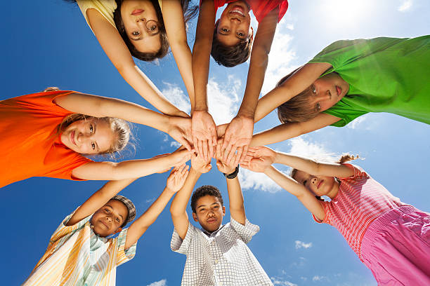 istock Seven children put arms in star shape 507313329