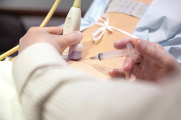 Woman receives cortisone shot in her back stock photo