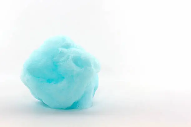 Blue spun sugar on white background, Cotton Candy.