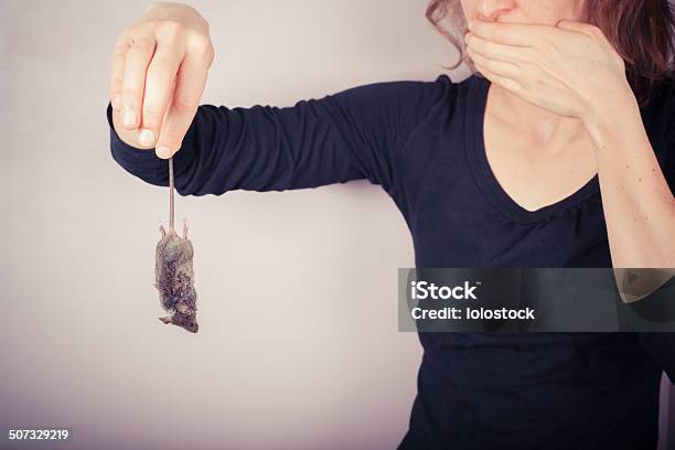 Disgusted Woman Holding Dead Mouse Stock Photo - Download Image Now - Fear, Mouse - Animal, One Person