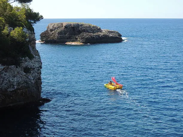 Paddleboat on ambitious voyage near Cala d'Or, Mallorca, Spain